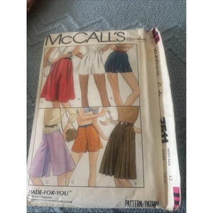 May include: A McCall's sewing pattern envelope for miss size 12, waist 26.5 inches. The front features illustrations of various skirt and short styles labeled A, B, and C, including a red skirt, white shorts, blue shorts, purple culottes, and brown skirts.