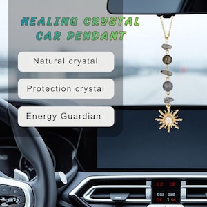 May include: A car pendant hanging from a rearview mirror, featuring a gold-toned chain with alternating grey natural stone beads and a sun-shaped charm with a central stone. Text on the image reads HEALING CRYSTAL CAR PENDANT, Natural crystal, Protection crystal, and Energy Guardian.