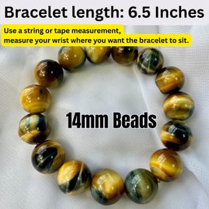 May include: A bracelet made of round, polished beads in shades of gold, brown, and blue. The bracelet is approximately 6.5 inches in length and features 14mm beads. The image includes text about measuring the wrist for fit.
