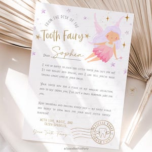 May include: A Tooth Fairy letter with a fairy illustration in pink and purple. The letter is addressed to Sophia and includes text about the tooth fairy's visit, with a Tooth Fairy stamp.