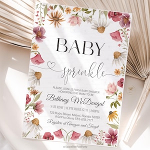 May include: Baby sprinkle invitation with floral border. The invitation features the words "BABY sprinkle" in elegant script. The invitation includes the name "Bethany McDougal" and event details. The invitation is decorated with watercolor flowers.