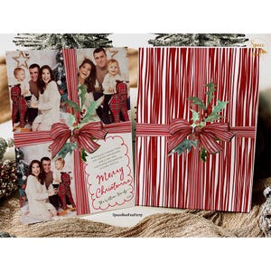 May include: Christmas cards featuring family photos, adorned with red and white striped ribbon and holly accents. One card displays a family photo with the text "Merry Christmas" and the family name. The other card has a red and white striped design.