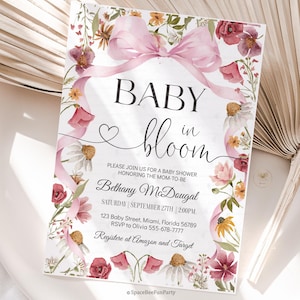 May include: Baby shower invitation with a floral design. The invitation features a pink bow, flowers, and the text "BABY in bloom." The invitation includes the name Bethany McDougal, date, time, and RSVP information.