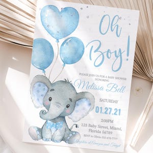 May include: Baby shower invitation with a watercolor illustration of a gray elephant holding blue balloons. The text "Oh Boy!" is written in blue script. The invitation includes the date, time, and location.