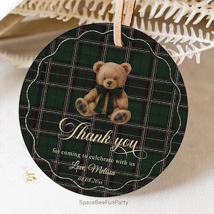 May include: Round gift tag with a green and black plaid pattern and a scalloped edge. A brown teddy bear with a black bow sits above the words "Thank you" in gold script. The tag includes the text "for coming to celebrate with us" and "Love Melissa".