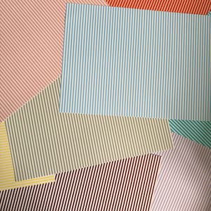 May include: A collection of rectangular paper sheets featuring various colored vertical and diagonal stripes. The patterns include light blue, red, beige, yellow, teal, purple, and dark red thin lines against a white background, layered together.