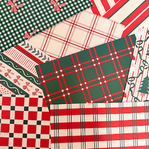 May include: A collection of overlapping sheets of wrapping paper featuring various holiday-themed patterns including red and green gingham with bows, red and white stripes, plaid designs, and a print with Christmas trees and Santa Claus figures.