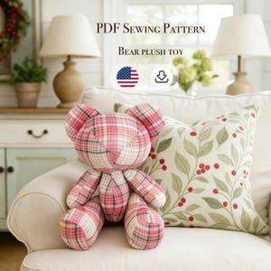 May include: A handmade bear plush toy made from pink and white plaid fabric. The bear is sitting on a cream-colored sofa next to a decorative pillow. The text "PDF Sewing Pattern" and "Bear Plush Toy" are visible.