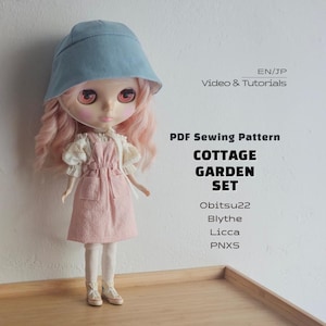 May include: A doll with long pink hair wearing a light blue bucket hat, a white blouse with lace sleeves, and a pink pinafore dress. Text reads: EN/JP Video & Tutorials, PDF Sewing Pattern, COTTAGE GARDEN SET, Obitsu22, Blythe, Licca, PNXS.