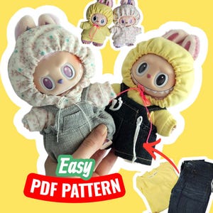 May include: Two plush dolls with bunny ears and hooded outfits. One doll wears a floral print hood and overalls, the other a yellow hood and denim overalls. The image includes a yellow t-shirt and denim shorts. Text reads "Easy PDF Pattern."