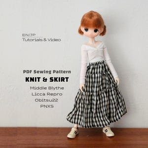 May include: A doll with auburn hair wearing a white long-sleeve top and a black and white gingham skirt. Text reads: EN/JP Tutorials & Video, PDF Sewing Pattern KNIT & SKIRT, Middle Blythe, Licca Repro, Obitsu22, PNXS. The doll wears white sneakers.
