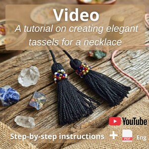 May include: Two black thread tassels featuring decorative bands of small red, blue, gold, and white beads. The text Video A tutorial on creating elegant tassels for a necklace is visible along with a YouTube icon and a PDF icon labeled Eng.