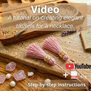 May include: Two light pink thread tassels with beaded caps featuring white, gold, and pink seed beads. The image includes text reading Video A tutorial on creating elegant tassels for a necklace, YouTube, and Step-by-step instructions.