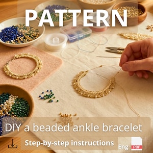 May include: A craft project featuring a partially assembled gold and white beaded ankle bracelet, a finished gold beaded bracelet, bowls of assorted blue, green, and gold beads, a needle, thread, and scissors on a light fabric surface.