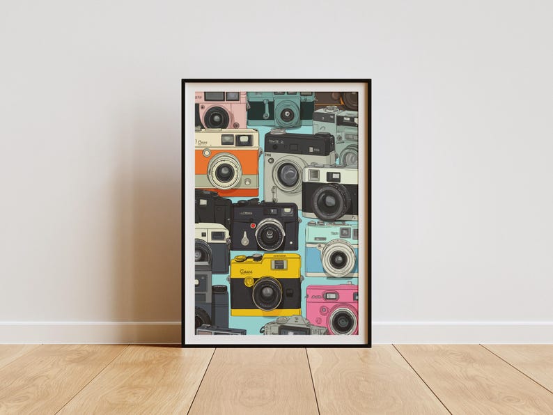 May include: A framed art print showcasing a collection of vintage cameras in a variety of colours, such as pink, orange, black, and yellow. The cameras are set against a light blue backdrop, creating a retro aesthetic.