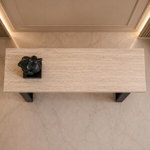Modern sofa table featuring rectangular travertine top and black steel legs
Elegant entryway console table crafted from authentic beige travertine
Contemporary stone console table with luxury hallway styling