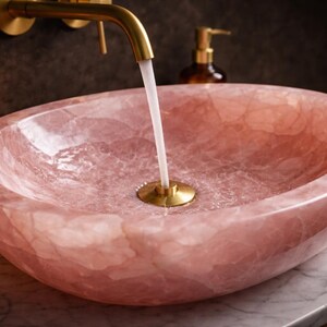 Side view of luxury rose quartz bathroom vessel sink highlighting thick natural stone and smooth polished edges