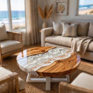 May include: Round wooden coffee table with a glossy finish. The table features a unique design with a river of white resin flowing through the center of the wood. The table is supported by a white base. The table is approximately 40 inches in diameter.