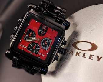 Oakley Minute Machine Chronograph - Reloj cuadrado de acero negro con esfera roja, estilo industrial Y2K