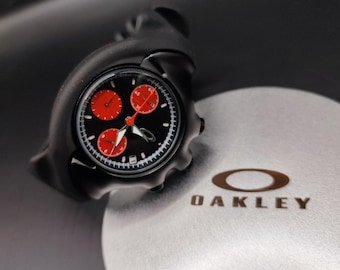 Reloj Oakley estilo Detonator: caja negra, subesfera roja, reloj futurista con diseño Y2K.