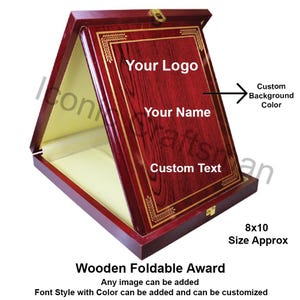 May include: A wooden foldable award in a hinged box. The award has a reddish-brown finish with gold accents and text that reads "Your Logo", "Your Name", and "Custom Text". The approximate size is 8x10 inches.