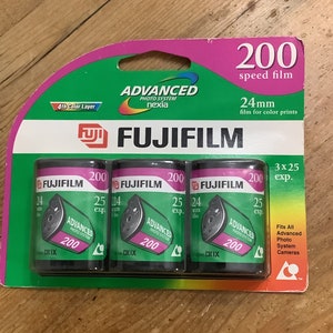 May include: A pack of three 200 speed Fujifilm 24mm film cartridges for color prints. The cartridges are green and black with the Fujifilm logo and the words "Advanced Photo System" and "200". The pack is pink and green with the words "200 speed film" and "24mm film for color prints".