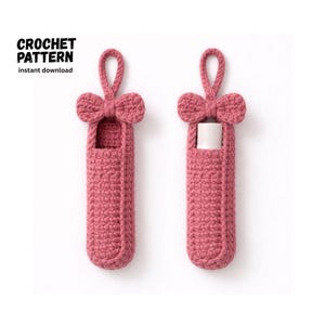 Pode incluir: Duas capas de bálsamo labial rosa de crochê com um detalhe de laço na parte superior. Uma capa está vazia e a outra contém um tubo de bálsamo labial branco. O texto "CROCHET PATTERN instant download" está no canto superior esquerdo.
