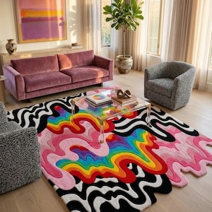 May include: A rectangular area rug featuring a vibrant, multi-colored design with wavy, liquid-like patterns in shades of rainbow, pink, black, and white. The rug has an irregular, flowing edge that mimics a melting effect across the floor.