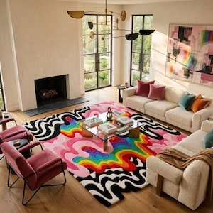 May include: A large rectangular area rug featuring a vibrant, multi-colored abstract design with flowing, wavy lines in bright rainbow hues of red, orange, yellow, green, blue, and purple, contrasted by bold, thick black and white wavy borders.