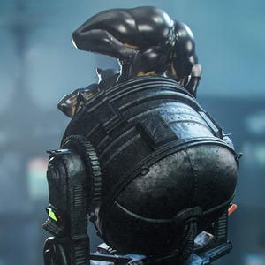 May include: A dark, metallic sculpture of a futuristic, mechanical object. The object has a rounded, bulbous body with intricate details, gears, and a figure on top. The color is primarily black with some green and orange accents. The overall design suggests a science fiction or industrial theme.