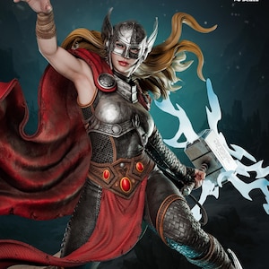 May include: A detailed 1:6 scale figure of a female warrior, in metallic armour and a red cape. She holds a glowing hammer and wears a helmet with wing-like accents. The figure is dynamically posed, with text indicating it's pre-supported and available on Patreon.