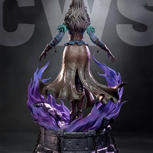 May include: A detailed statue of a woman with long gray hair, wearing a blue top, brown skirt, and boots. She stands on a stone base with purple flames. The statue has a dramatic pose with arms outstretched.