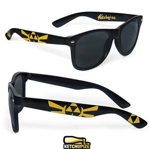 Picture of black sunglasses, hand-painted with a Legend of Zelda inspired design, including yellow triforce and wingcrest, in black and yellow colors.