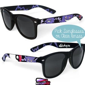 Picture of black sunglasses, hand-painted with a Pokémon design, including purple Gengar and red and white Pokeballs on a black background, in white, purple and red colors.