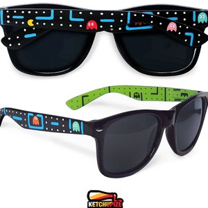 Picture of black sunglasses, hand-painted with an Arcade video game inspired design, including yellow, red, pink, orange and blue monsters and ghosts, white dots and blue lines.