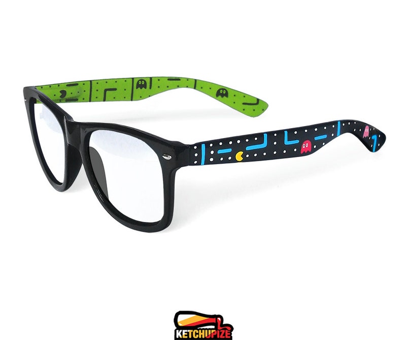 Picture of black clear lens glasses, hand-painted with an Arcade video game inspired design, including yellow, red, pink, orange and blue monsters and ghosts, white dots and blue lines.