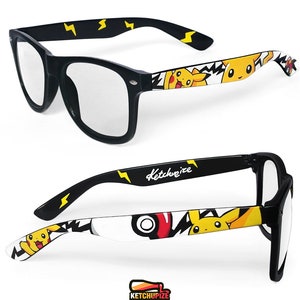 Picture of black clear lens glasses, hand-painted with a Pokemon design, including yellow Pikachu, black bolts and red and white Pokeballs on a white background, in white, black, yellow and red colors.