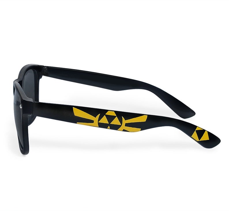 Picture of black sunglasses, hand-painted with a Legend of Zelda inspired design, including yellow triforce and wingcrest, in black and yellow colors.