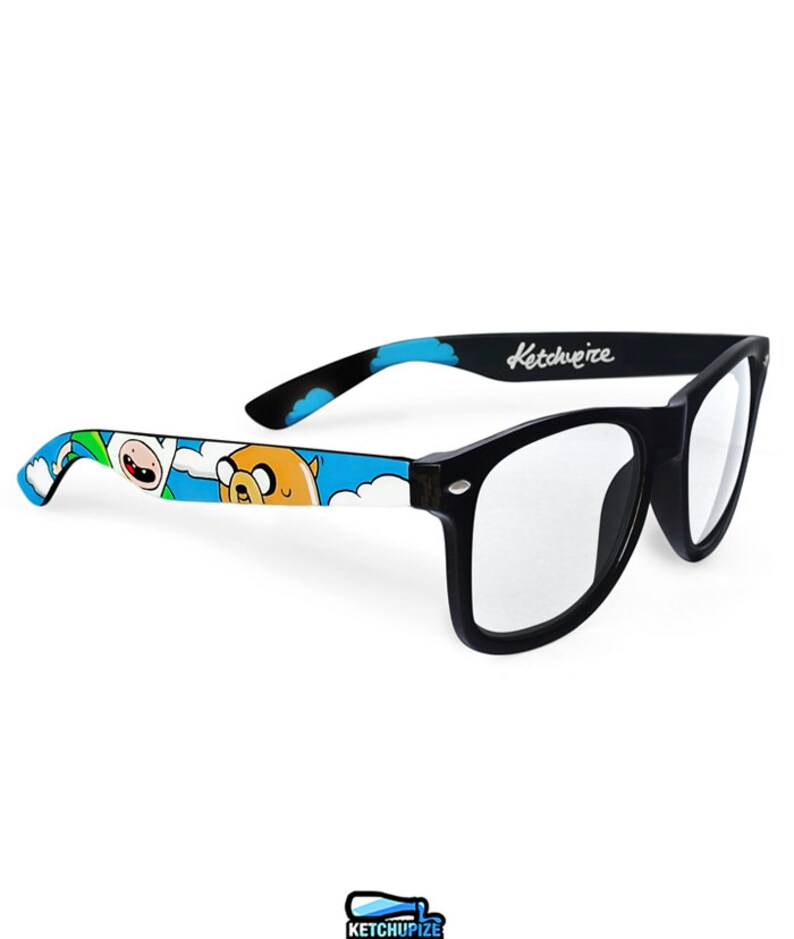 Picture of black clear lens glasses, hand-painted with an Adventure Time inspired design, including Finn the human and Jake the dog on a blue background with white clouds, in white, blue and yellow colors.