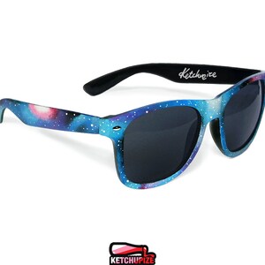 Picture of black sunglasses, hand-painted with a galaxy design in blue, purple and pink colors.