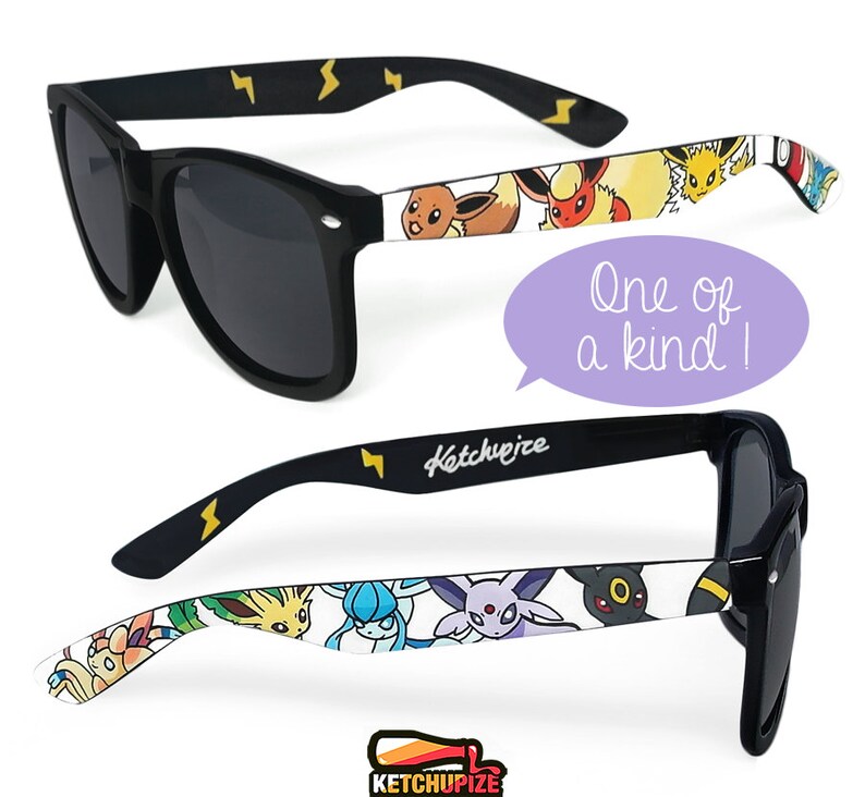 Picture of black sunglasses, hand-painted with a Pokémon design, including  Eevee Evolutions, Vaporeon, Jolteon, Flareon, Espeon, Umbreon, Leafeon, Glaceon, Sylveon, on a white background.