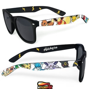 Picture of black sunglasses, hand-painted with a Pokémon design, including  Eevee Evolutions, Vaporeon, Jolteon, Flareon, Espeon, Umbreon, Leafeon, Glaceon, Sylveon, on a white background.