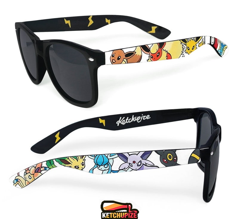 Picture of black sunglasses, hand-painted with a Pokémon design, including  Eevee Evolutions, Vaporeon, Jolteon, Flareon, Espeon, Umbreon, Leafeon, Glaceon, Sylveon, on a white background.