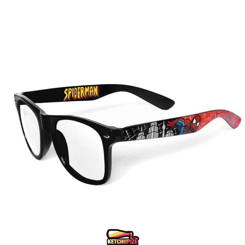 Picture of black clear lens glasses, hand-painted with a Spiderman comic theme design, showing Spiderman against spider web and the city skyline, in red, blue and black colors.