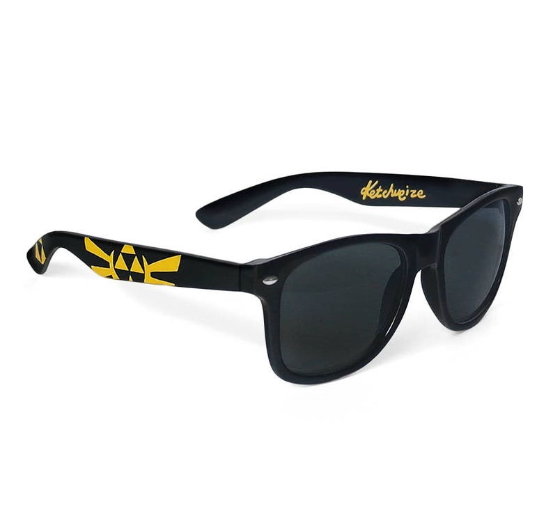 Picture of black sunglasses, hand-painted with a Legend of Zelda inspired design, including yellow triforce and wingcrest, in black and yellow colors.