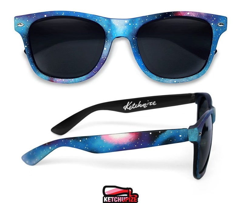 Picture of black sunglasses, hand-painted with a galaxy design in blue, purple and pink colors.