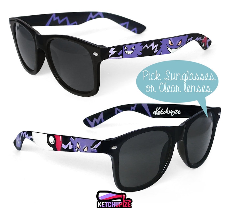 Picture of black sunglasses, hand-painted with a Pokémon design, including purple Gengar and red and white Pokeballs on a black background, in white, purple and red colors.