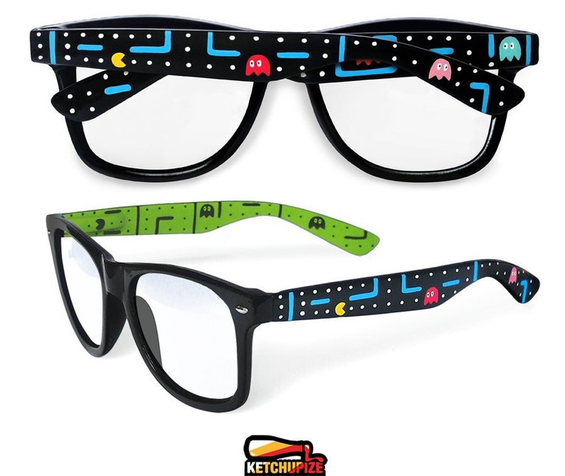 Picture of black prescription glasses, hand-painted with an Arcade video game inspired design, including yellow, red, pink, orange and blue monsters and ghosts, white dots and blue lines.