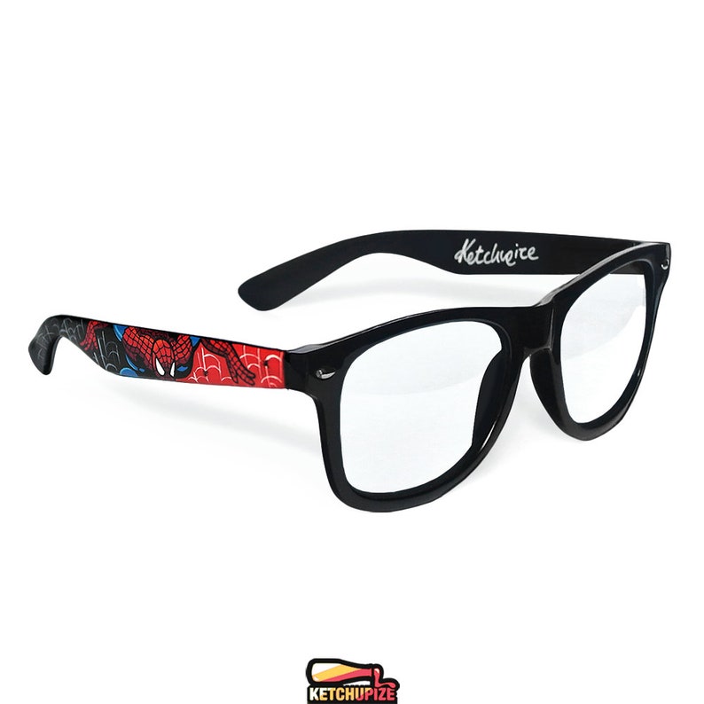 Picture of black prescription glasses, hand-painted with a Spiderman comic theme design, showing Spiderman against spider web and the city skyline, in red, blue and black colors.