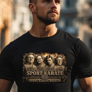 May include: Black t-shirt with a graphic depicting four men and the text "The Mount Rushmore of Sport Karate." The design includes the names of the men and the words "Sport Karate Museum."